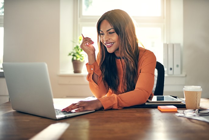 Woman working with ease in front of her computer at home